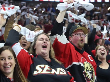 Ottawa Senators fans celebrate their third goal against the Rangers.