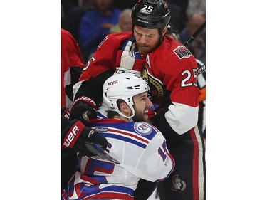 The Ottawa Senators' Chris Neil Saturday battles against the Rangers' Tanner Glass.