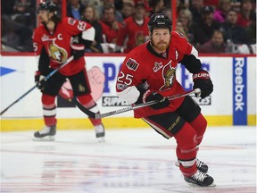 The Ottawa Senators' Chris Neil tracks the play as he skates up ice.