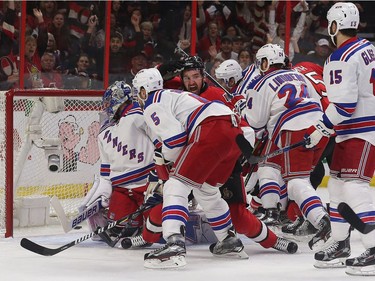 The Ottawa Senators' Mark Stone scores on New York Rangers goalie Henrik Lundqvist during the first period of Game 5.