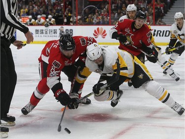 Making his NHL playoff debut, Colin White takes a faceoff against Penguins centre Matt Cullen during the first period on Tuesday night. Tony Caldwell/Postmedia