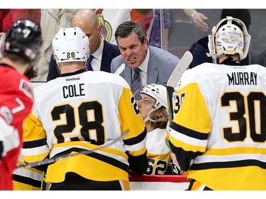 Penguins head coach Mike Sullivan makes a point to his players during a timeout in the third period.