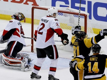 Pittsburgh Penguins' Phil Kessel (81) celebrates with teammate Chris Kunitz (14) after scoring on Ottawa Senators goalie Craig Anderson (41) during the third period of Game 2 of the Eastern Conference final in the NHL hockey Stanley Cup playoffs, Monday, May 15, 2017, in Pittsburgh. Senators' Dion Phaneuf (2) skates by at center.