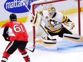 Pittsburgh goalie Matt Murray (30) makes a save on Ottawa right-winger Mark Stone during the second period of Game 4 in Ottawa on Friday night.