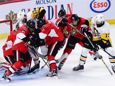 Pittsburgh Penguins right wing Bryan Rust (17) battles for the puck with Ottawa Senators centre Tom Pyatt (10) and Senators defenceman Chris Wideman (6) in front of Senators goalie Craig Anderson (41) during the first period of game six of the Eastern Conference final in the NHL Stanley Cup hockey playoffs in Ottawa on Tuesday, May 23, 2017.