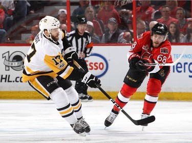 Bryan Rust #17 of the Pittsburgh Penguins takes a shot against Mike Hoffman #68 of the Ottawa Senators during the first period in Game Six of the Eastern Conference Final during the 2017 NHL Stanley Cup Playoffs at Canadian Tire Centre on May 23, 2017 in Ottawa, Canada.