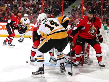 Chris Kunitz #14 of the Pittsburgh Penguins looks for the puck against Zack Smith #15 of the Ottawa Senators during the first period in Game Six of the Eastern Conference Final during the 2017 NHL Stanley Cup Playoffs at Canadian Tire Centre on May 23, 2017 in Ottawa, Canada.