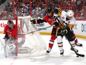 Sidney Crosby #87 of the Pittsburgh Penguins skates with the puck behind the net against Erik Karlsson #65 of the Ottawa Senators during the first period in Game Three of the Eastern Conference Final during the 2017 NHL Stanley Cup Playoffs at Canadian Tire Centre on May 17, 2017 in Ottawa, Canada.