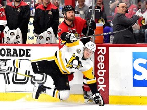 Jake Guentzel #59 of the Pittsburgh Penguins falls to the ice after colliding with Marc Methot #3 of the Ottawa Senators during the third period in Game Three of the Eastern Conference Final during the 2017 NHL Stanley Cup Playoffs at Canadian Tire Centre on May 17, 2017 in Ottawa, Canada.
