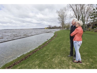 Randy Tivy and Beverly Reid look out towards the Ottawa River from a 100 year flood berm that was constructed to protect property along Kehoe Street in Britannia Village. May 3,2017