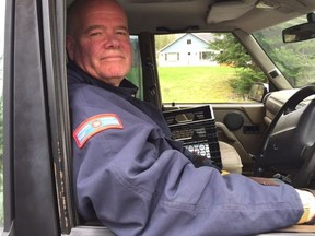 Rob McClenahan lost his home to flooding. He continues to deliver the mail on the street.