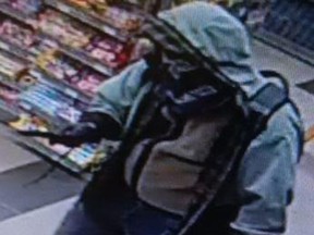 A suspect brandishes a knife in a holdup in a gas bar in Pembroke Tuesday.