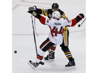 Pittsburgh Penguins' Ron Hainsey (65) checks Ottawa Senators' Jean-Gabriel Pageau (44) off the puck during the first period of Game 2 of the Eastern Conference final in the NHL hockey Stanley Cup playoffs, Monday, May 15, 2017, in Pittsburgh.