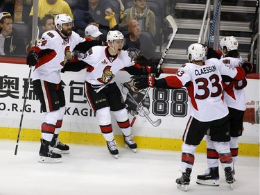 Ottawa Senators center Ryan Dzingel, second from left, celebrates with Viktor Stalberg (24), Fredrik Claesson (33) and Erik Karlsson (65) after scoring a goal against the Pittsburgh Penguins during the third period of Game 7 of the Eastern Conference final in the NHL Stanley Cup hockey playoffs in Pittsburgh, Thursday, May 25, 2017.