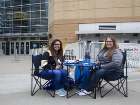 Sam Witucki, left, and Caitlynn Cook, both 22, were the first fans to show up at PPG Paints Arena in Pittsburgh, at 10 a.m. Saturday, nine hours before Game 1 of the Eastern Conference semifinals. They plan on watching the game on one of the screens outside.