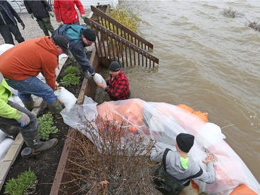 Sand bags are brought to help stop the Ottawa river from flooding cottages on Wilson rd in Rockland, May 08, 2017.