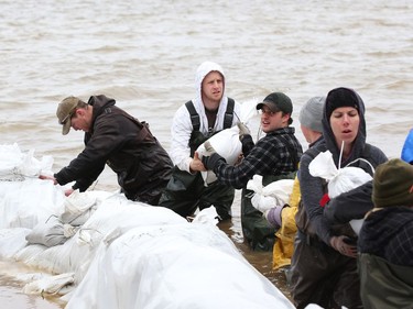 Sand bags are brought to help stop the Ottawa river from flooding cottages on Wilson rd in Rockland, May 08, 2017.