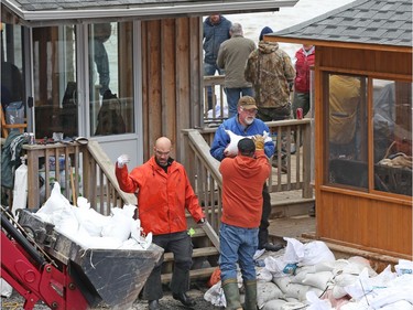 Sand bags are brought to help stop the Ottawa river from flooding cottages on Wilson rd in Rockland, May 08, 2017.