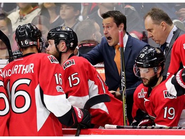 Senators head coach Guy Boucher makes a point to his players in the third period.