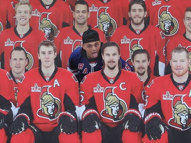 A New York Rangers fan gets his photo taken with the cardboard cutouts of Ottawa Senators before Game 5.