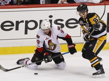 Ottawa Senators' Bobby Ryan (9) tries to control the puck in front of Pittsburgh Penguins' Sidney Crosby (87) during the first period of Game 2 of the Eastern Conference final in the NHL hockey Stanley Cup playoffs, Monday, May 15, 2017, in Pittsburgh.