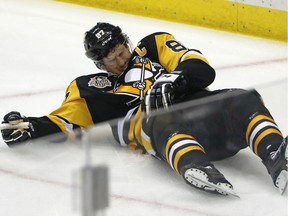 Pittsburgh Penguins' Sidney Crosby (87) lies on the ice after taking a hit from Washington Capitals' Matt Niskanen during the first period of Game 3 in an NHL Stanley Cup Eastern Conference semifinal hockey game against the Washington Capitals in Pittsburgh, Monday, May 1, 2017. One hit may have changed the tenor of the NHL playoffs. Penguins star Sidney Crosby's status going forward is uncertain.