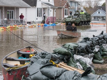 Soldiers in an armoured vehicle check with residents on Rue Glaude in Gatineau as flooding continues throughout the region in areas along the local rivers.