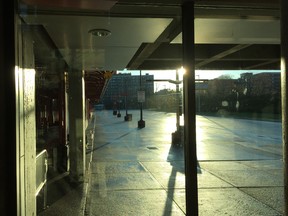 Sun reflects off the wet pavement at an OC Transpo station Tuesday morning.