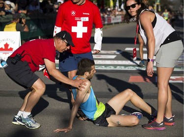 The medical team assists Adam Hortian at the finish line of the 10K race.