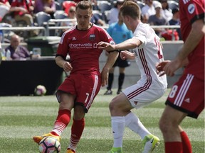 The Ottawa Fury's Ryan Williams kicks the ball as he is chased by the Richmond Kickers' Christopher Durkin during the second half of their USL soccer match at TD Place in Ottawa on Saturday, May 27, 2017.