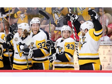 The Penguins bench celebrates the opening goal of Game 4 in the first period.