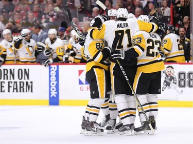 The Penguins celebrate after scoring in the second period.