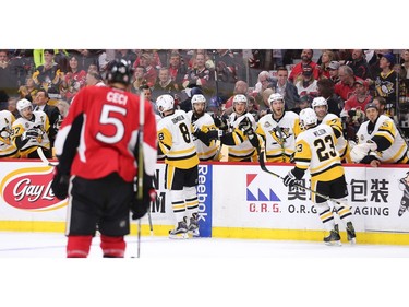 The Penguins celebrate after scoring in the second period.