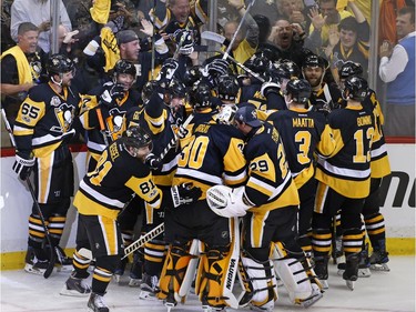 The Pittsburgh Penguins celebrate a game winning goal by Chris Kunitz in the second overtime period of Game 7 of the Eastern Conference final in the NHL Stanley Cup hockey playoffs in Pittsburgh, Friday, May 26, 2017. The Penguins won in double overtime 3-2 to advance to the Stanley Cup Finals.