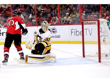 The Senators' Tom Pyatt and Penguins goalie Matthew Murray look back as the puck enters the net for Ottawa's second goal.