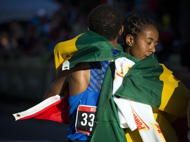 Women's winner Netsanet Gudeta hugs men's champion Leul Gebresilase after crossing the 10K race finish line at Tamarack Ottawa Race Weekend on Saturday, May 27, 2017.