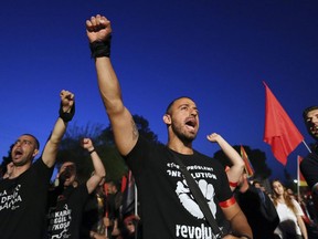 Turkish Cypriots shout slogans after they meet with Greek Cypriots during May Day celebrations inside the U.N buffer zone in Nicosia, Monday, May 1, 2017. Greek and Turkish Cypriots are marking May Day with a "Rock for Peace" concert in support of talks aimed at reunifying ethnically divided Cyprus. Journalist Terry Glavin writes on the reasons why this nation is still divided.