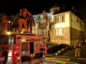Firefighters at a two-alarm fire in Vanier early Saturday.