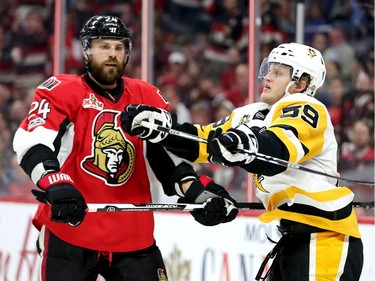 Viktor Stalberg (L) and Jake Guentzel jostle in the second period as the Ottawa Senators take on the Pittsburgh Penguins in Game 3 of the NHL Eastern Conference Finals at the Canadian Tire Centre.  Wayne Cuddington/Postmedia