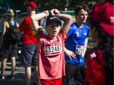 Vincent Polan tries to cool down after finishing the 5k race.