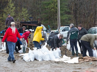 Volunteers fill sandbags at the Constance Bay Community Centre as the residents of Constance Bay deal with the Ottawa River rising to record levels and  flooding the region.