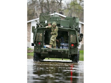 Water levels in Gatineau have started to come down in the flooding but major damage is starting to show Saturday May 13, 2017. A military LAV makes it's way down Rue Saint-Paul to deliver water to people in the area.