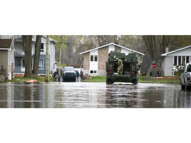 Water levels in Gatineau have started to come down in the flooding but major damage is starting to show Saturday May 13, 2017. A military LAV makes it's way down Rue Saint-Paul at Rue Riviera to deliver water.