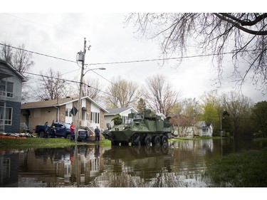 Water levels in Gatineau have started to come down in the flooding but major damage is starting to show Saturday May 13, 2017. A military LAV makes it's way down Rue Saint-Paul at Rue Riviera to deliver water.