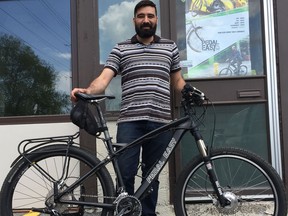 Claudio Wensel, co-owner of Pedal Easy, stands outside his Bells Corners store with a Responder model e-bike. The bike’s battery is discretely tucked into the small saddlebag under the seat.