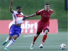 Fury FC's Onua Obasi, right, tries to pull away from Toronto FC's Jordan Hamilton during a Canadian Championship semifinal match on May 23. Darren Brown/Postmedia