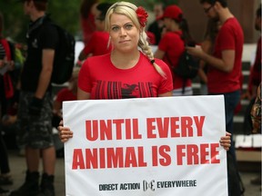 Jevranne Martel of the Ottawa Animal Defense League stands with her poster prior to the animal rights march on Saturday, June 17, 2017.