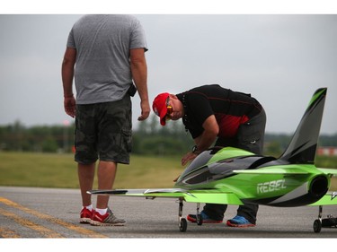 Pilots, spotters and spectators were at the Carp Airport to enjoy the miniature radio-controlled jet planes taking flight Saturday June 17, 2017. Elckar Monsalve gets the Rebel Pro ready for flight.   Ashley Fraser/Postmedia
Ashley Fraser, Postmedia