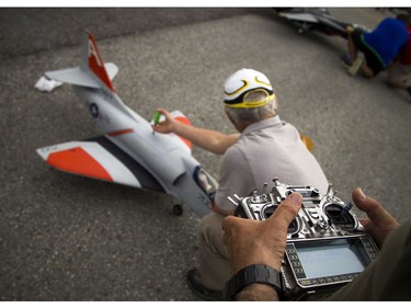 Pilots, spotters and spectators were at the Carp Airport to enjoy the miniature radio-controlled jet planes taking flight Saturday June 17, 2017. Pilot Eric Dainty getting the very old A4 Skyhawk, the only glow fuel ducted fan jet ready for flight Saturday.    Ashley Fraser/Postmedia
Ashley Fraser, Postmedia