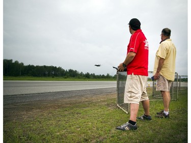 Pilots, spotters and spectators were at the Carp Airport to enjoy the miniature radio-controlled jet planes taking flight Saturday June 17, 2017. Pilot Sandro Novelli who was flying a F14 Tomcat with Blair Howkins who was spotting.   Ashley Fraser/Postmedia
Ashley Fraser, Postmedia